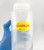 Lab technician holding bottle with cryogenic Sampled label attached
