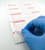 Lab technician peeling back a QUARANTINE Laser Printer Label
