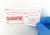 Laboratory manager applying a Quarantine label in a pharmaceutical facility