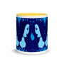 White ceramic mug with mirrored blue Athena portraits, yellow interior, and deep-blue floral background