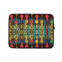Klimt Sampling laptop sleeve with repeating afro-portrait grid in red, yellow and green on black.