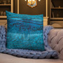 Teal and navy abstract wave-texture Da Vinci pillow on tufted sofa with cornflower chunky knit.