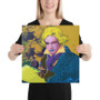Blonde woman holding square Beethoven Blond Blue canvas showing neon hair and blue coat scale.