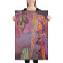 Woman holding vertical Botticelli Birth of Venus Orange Purple canvas with pink-magenta sky.