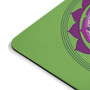 Close-up rounded corner of lime green mousepad showing purple lotus graphic and black rubber edge.