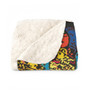 Folded Klimt Beethoven Portrait sherpa blanket revealing cream fleece lining and cyan-yellow print.