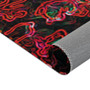 Rubens Adam and Eve neon rug corner flipped showing grey non-slip backing under red-pink glow.