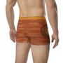 Rear Da Vinci Orange Peach boxers with Vitruvian Man circular seal on orange wood-grain thigh.