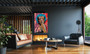 Monroe peach canvas over fireplace: turquoise Marilyn above lit hearth with cognac leather sofa.