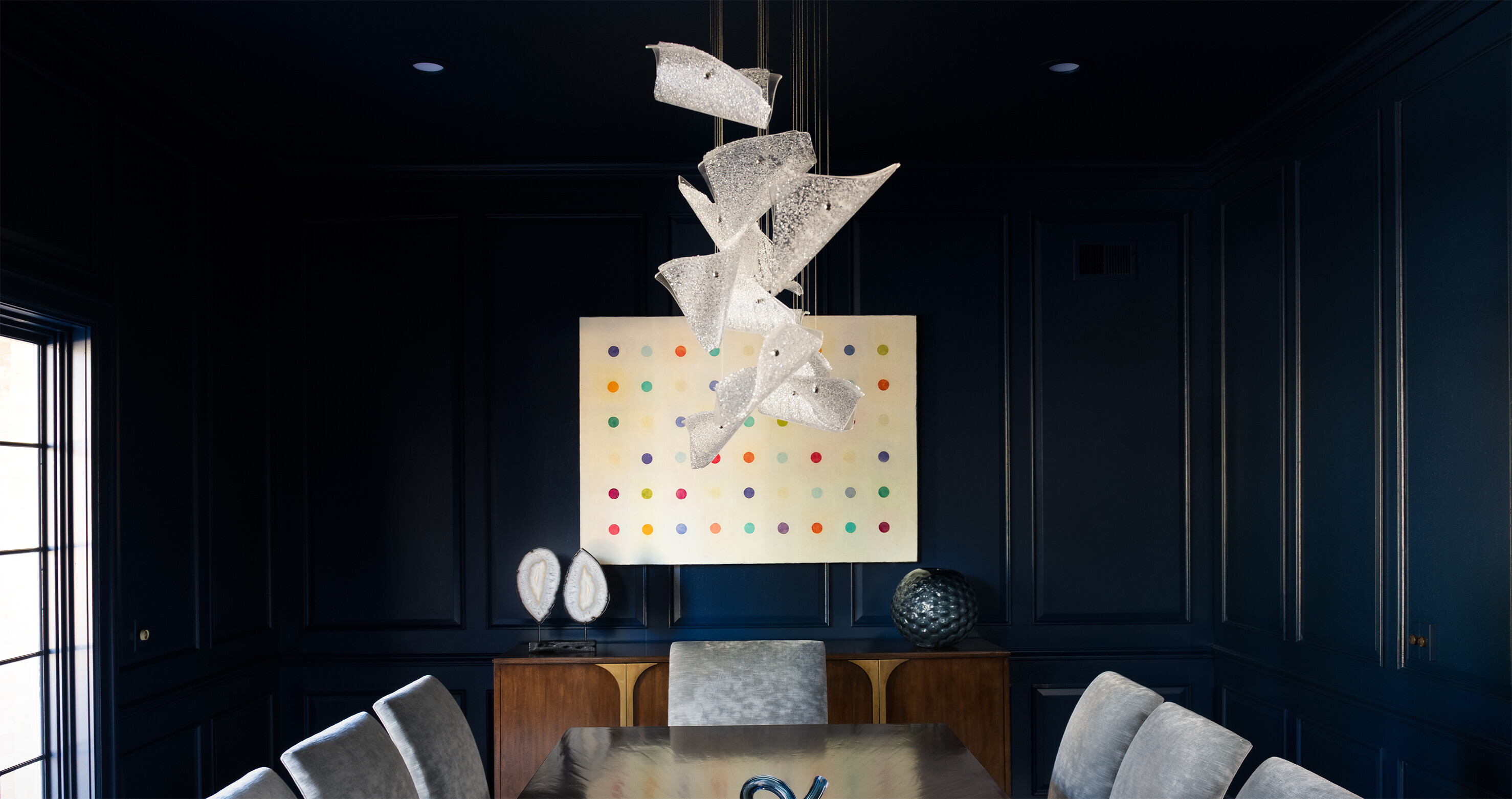 Contemporary Luxury handcrafted lighting fixture featuring sculptural glass and precision metalwork showcased in a modern DINING ROOM with open-plan living, gallery-like walls, and refined finishes.