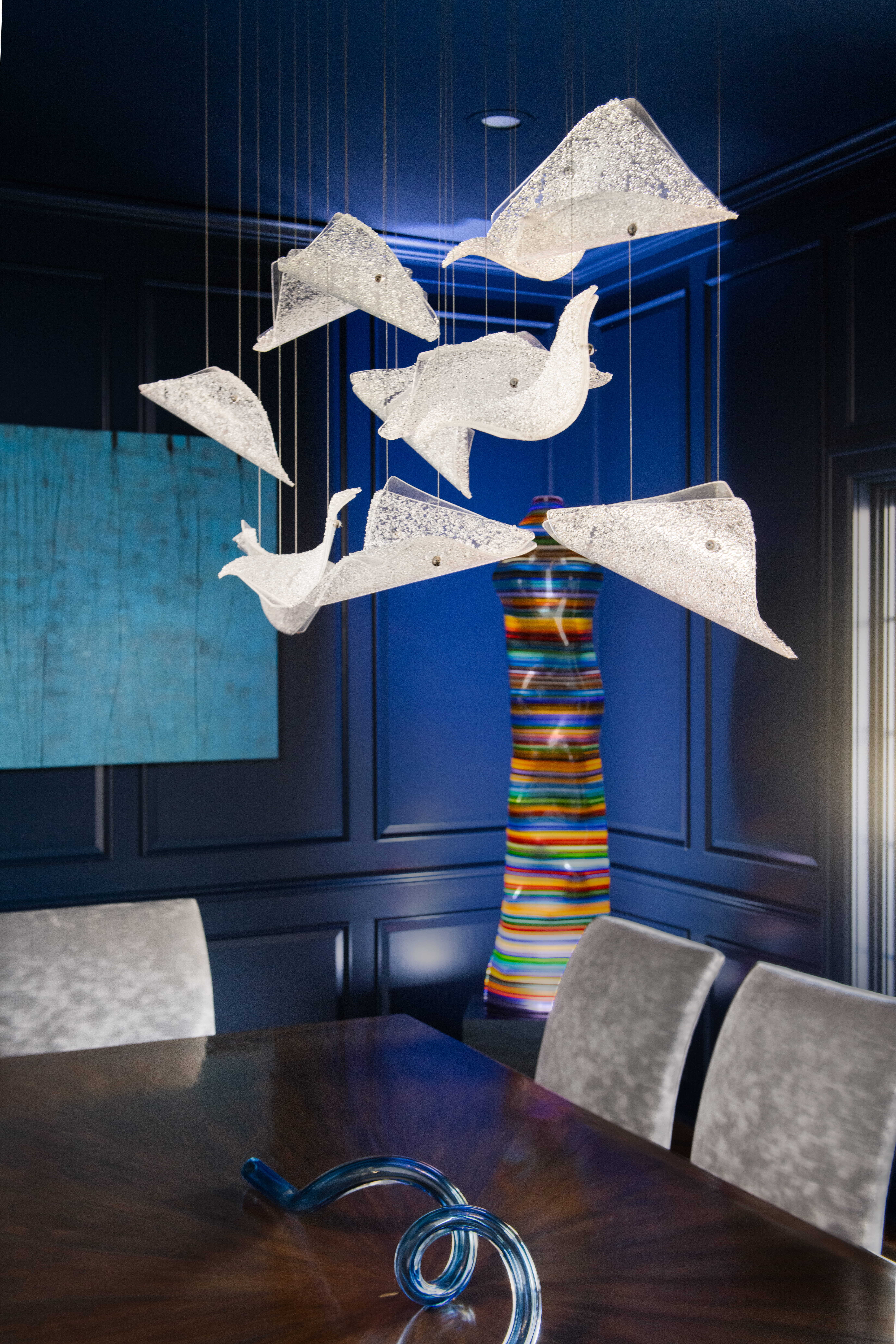 Handcrafted in the USA, this sculptural studio glass lighting design enhances a modern luxury residence with clean lines and curated finishes.