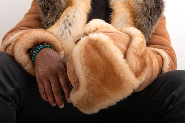 man holding a Russian Style Sheepskin Hat 