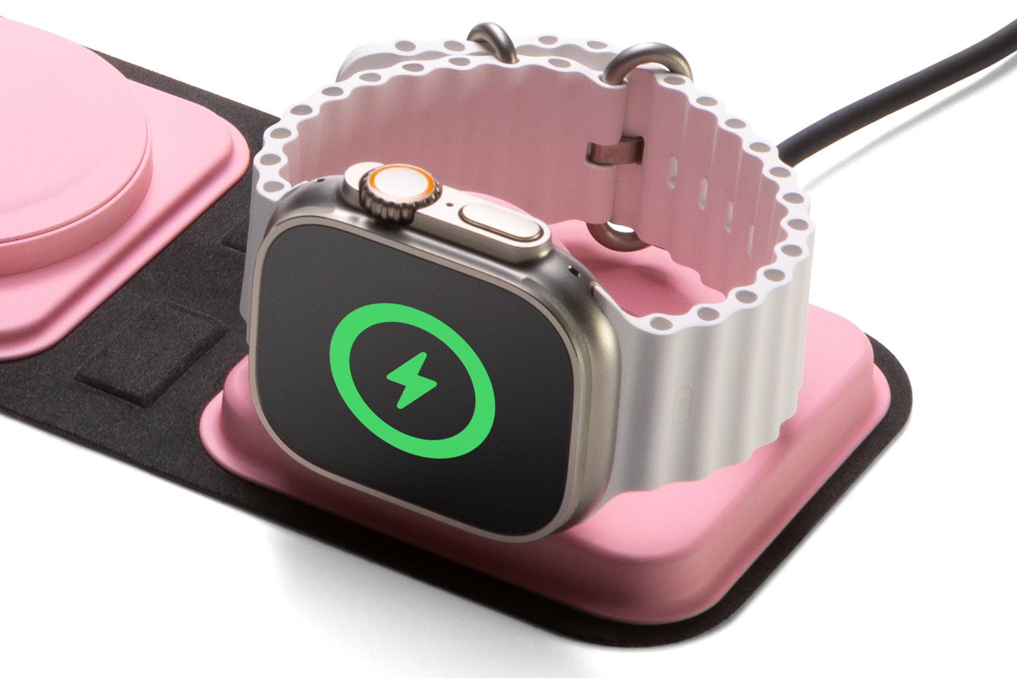 Apple Watch Ultra charging on a pink wireless charger