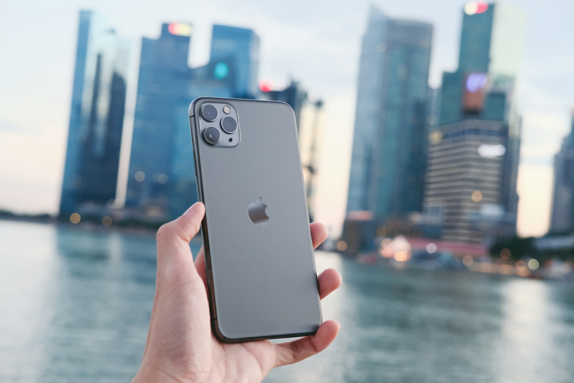 a gray iPhone against a cityscape