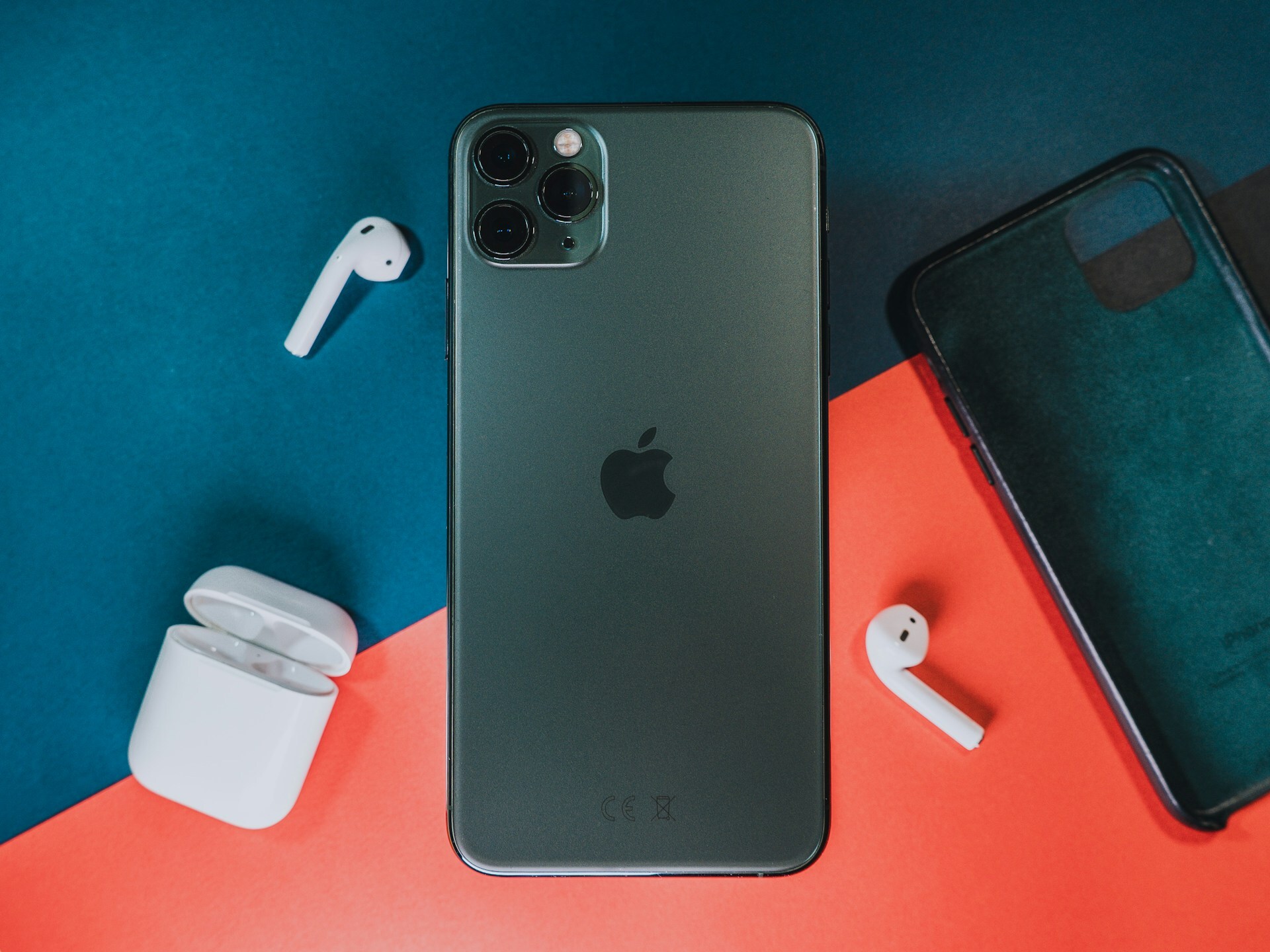 an iPhone on a colorful desk with AirPods