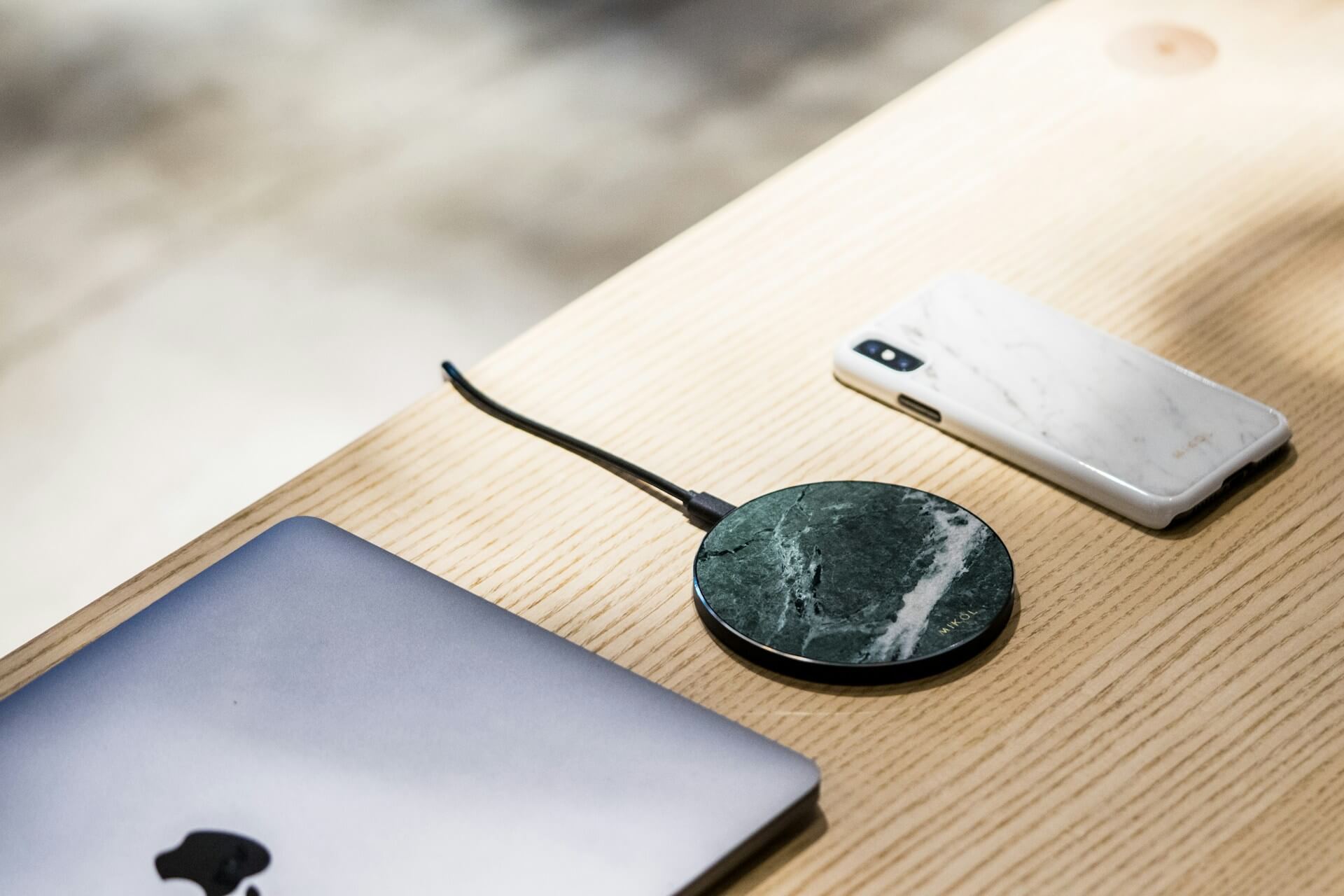 a MagSafe charger and Apple devices on a desk