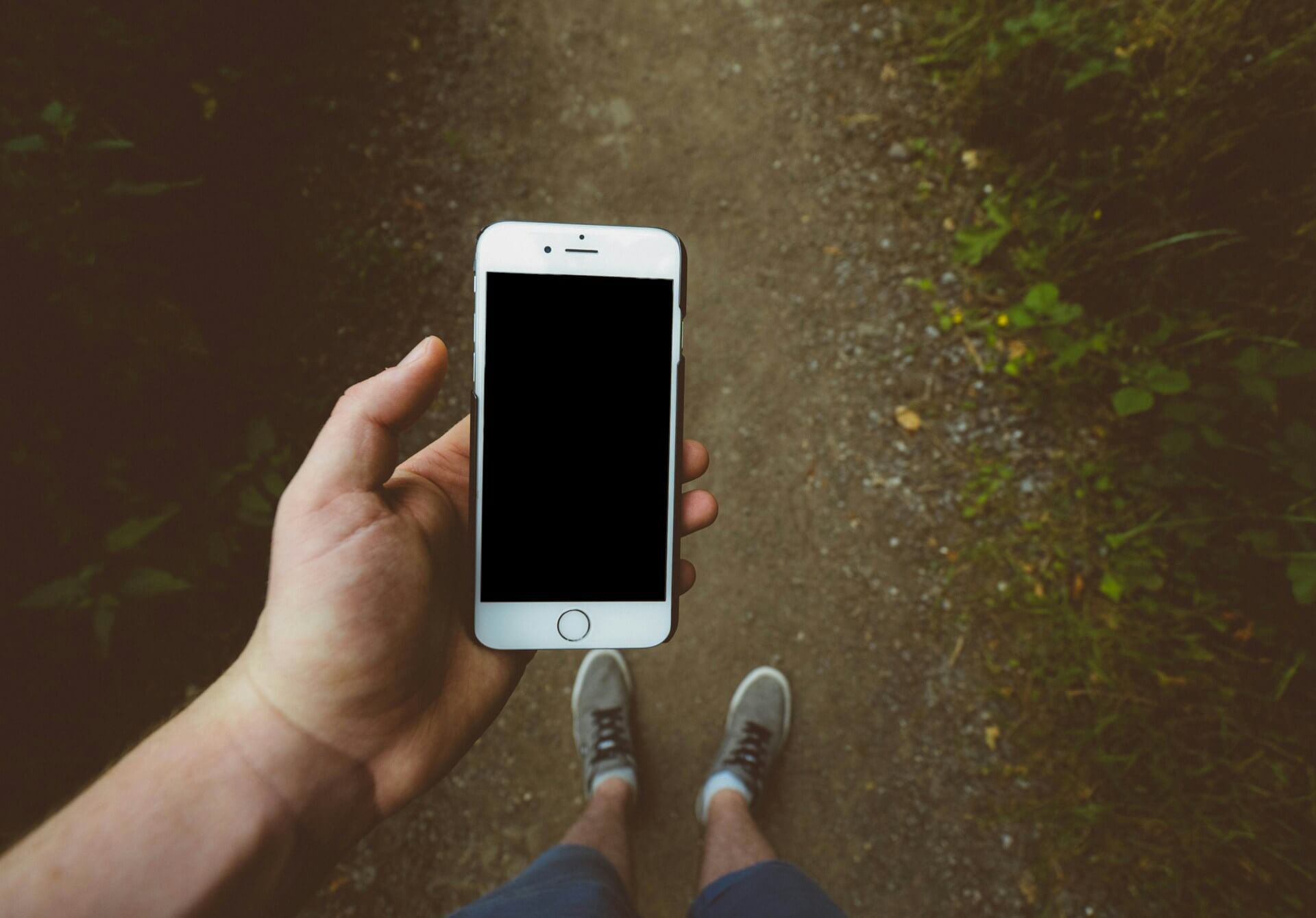 person-iPhone-dirt-road