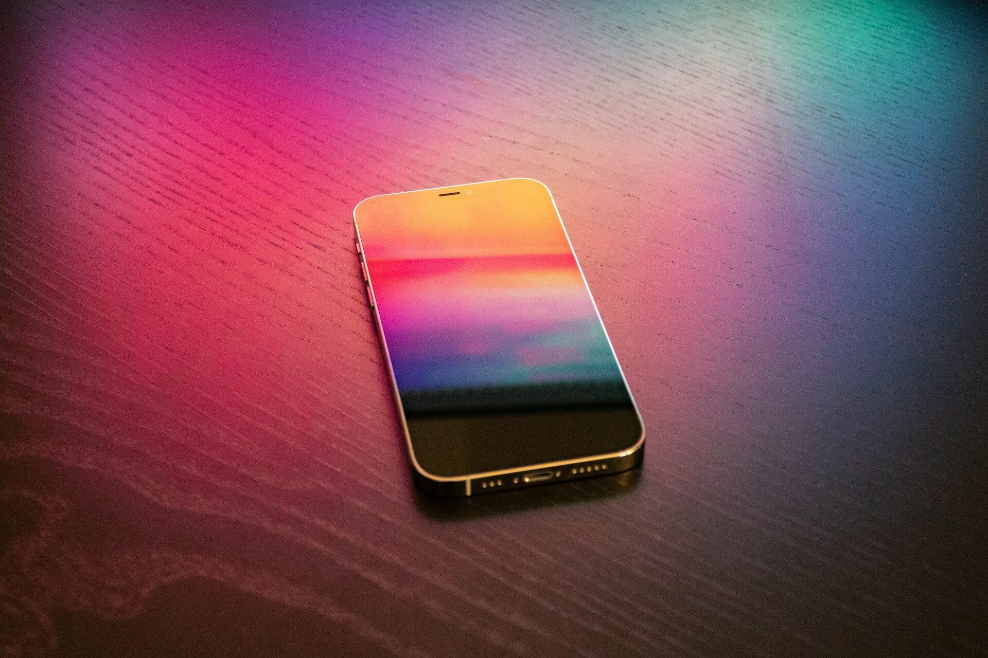 a phone reflecting a pink and magenta hue