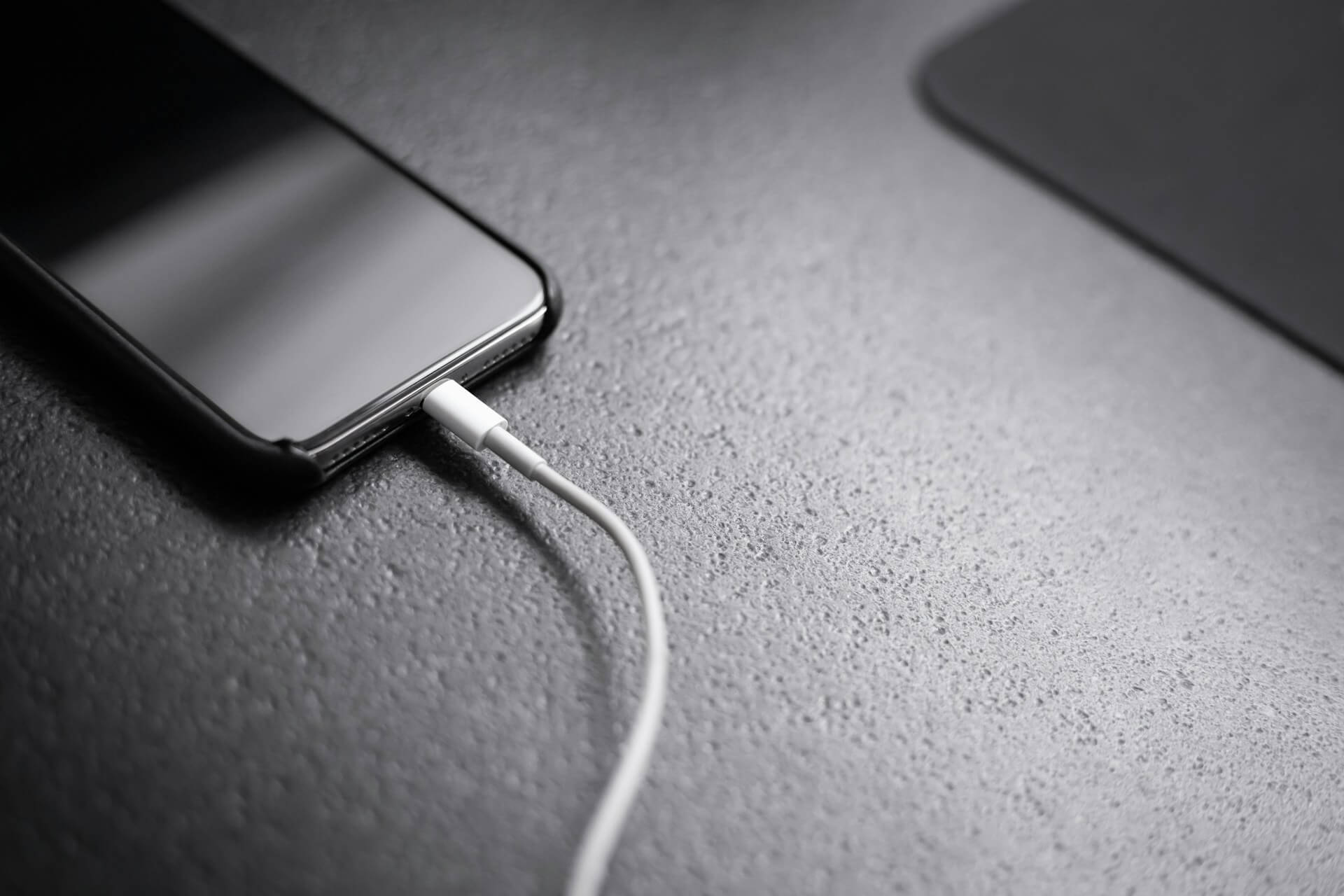 smartphone connected to charging cable