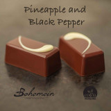 Bohemein Pineapple Black Pepper Ganache. Tangy tropical pineapple spiked with gently smoked granules of pepper, encased in dark chocolate.
