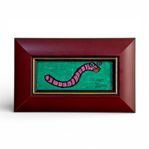 Hand-painted framed artwork of a simple pink worm on a textured green background, created by Toronto artist Mystiic Khalifa.