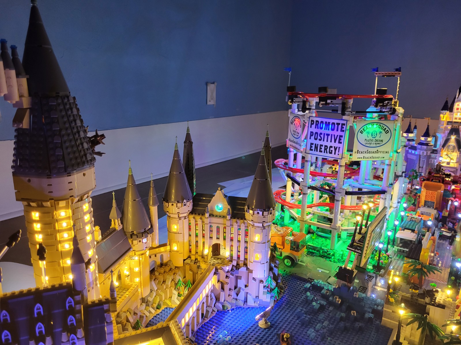 Beach Squad Lego Window Display Hogwarts and roller coaster lit up at night