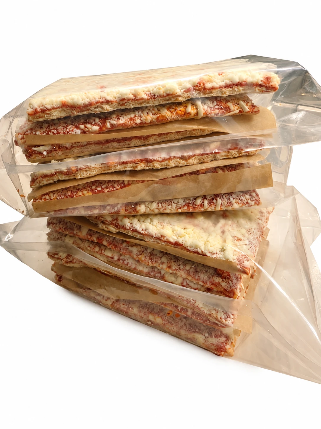 Stack of wrapped rectangle pizzas ready for the freezer
