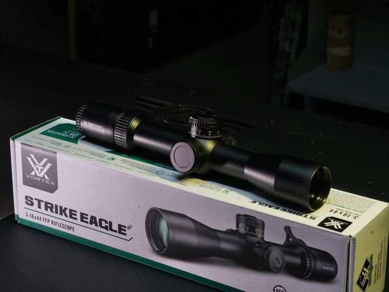 Close-up of Vortex Strike Eagle 3-18x44 optic showing exposed elevation turret and first focal plane reticle