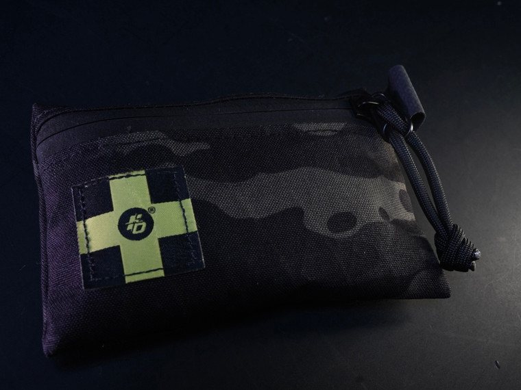 Flatline Ops OH-SH*T-KIT Ultralight Waterproof Micro Abrasion Kit featuring XPAC waterproof construction with blister care, friction prevention, and first-aid essentials for hunting, hiking, and range use.