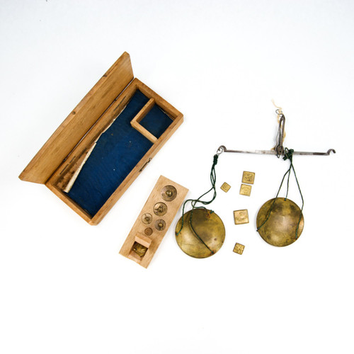 Antique balance with weights in a wooden box.
