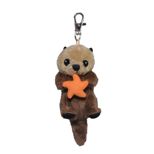 Cute small sea otter key ring holding a red star