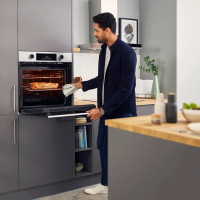 Beko AeroPerfect™ Electric Single Oven - Stainless Steel - Single oven in modern kitchen with man using oven