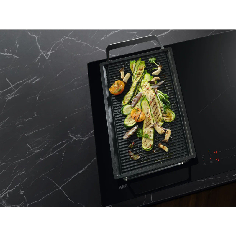 AEG SaphirMatt TO64IB00FZ 60cm Induction Hob - Matt Black - Pan cooking food on hob shot