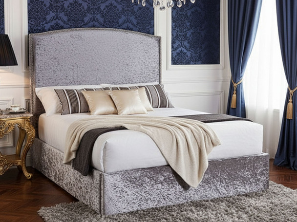  Discover the Esupasaver Konya Ottoman Storage Bed Frame, featuring a stylish curved headboard and elegant chrome nail detailing for a chic bedroom upgrade