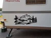 Bigfoot Sasquatch mountain landscape vinyl decal V2 featuring walking cryptid silhouette, mountain peaks, evergreen forest and pine trees for RV campers and travel trailers