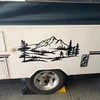 Bigfoot Sasquatch mountain landscape vinyl decal V2 featuring walking cryptid silhouette, mountain peaks, evergreen forest and pine trees for RV campers and travel trailers