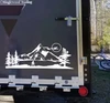Bigfoot Sasquatch moon mountain landscape vinyl decal featuring walking cryptid silhouette, full moon, mountain peaks, pine trees and lake for RV campers and travel trailers