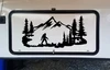 Bigfoot Sasquatch walking through mountain forest scene with evergreen pine trees and rugged peaks vinyl decal for RV camper and travel trailer
