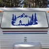 Bigfoot Sasquatch walking through mountain forest scene with evergreen pine trees and rugged peaks vinyl decal for RV camper and travel trailer