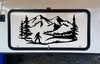 Bigfoot Sasquatch walking beside a wilderness lake with mountain peaks and evergreen pine trees scenic vinyl decal for RV camper and travel trailer