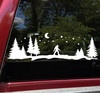Bigfoot Sasquatch walking through evergreen pine trees beneath a crescent moon and starry night sky horizontal forest silhouette vinyl decal for RV camper and travel trailer