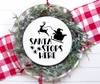 White Santa Stops Here Christmas vinyl window decal featuring Santa Claus in a sleigh pulled by a reindeer above decorative holiday lettering and stars