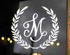 Personalized monogram vinyl decal featuring a custom initial letter surrounded by a classic laurel wreath