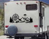 Back of Camper RV with a large black vinyl decal featuring a compass, and an alien spaceship abducting a man over a mountain forest scene