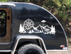 Side of black teardrop Camper RV with a large white vinyl decal featuring a compass, and an alien spaceship abducting a man over a mountain forest scene