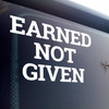Earned Not Given vinyl decal featuring bold motivational lettering emphasizing discipline and earned success on a white background