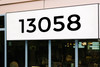 Large storefront address numbers vinyl decal in Montserrat font with modern minimalist business signage style