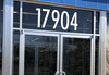 Large storefront address numbers vinyl decal in Futura Bold font with modern minimalist business signage style