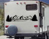 Mountain forest scene vinyl sticker decal applied to RV travel trailer window with pine trees and wilderness landscape design