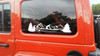 Mountain forest scene vinyl sticker decal applied to RV travel trailer window with pine trees and wilderness landscape design